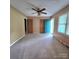 Bedroom with neutral carpet, and a bright blue door at 6573 Weldon Nw Cir # 22, Concord, NC 28027