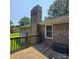 Deck with a brick chimney and lush green lawn, perfect for relaxation or entertaining at 6573 Weldon Nw Cir # 22, Concord, NC 28027