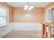 Cozy dining room featuring carpet floors, wainscoting and a decorative chandelier at 6573 Weldon Nw Cir # 22, Concord, NC 28027