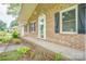 Brick ranch style home featuring a covered front entrance and well-kept flower bed at 6573 Weldon Nw Cir # 22, Concord, NC 28027
