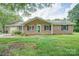 Brick ranch-style home with dark shutters, a green front door and well manicured flower bed at 6573 Weldon Nw Cir # 22, Concord, NC 28027