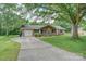 Charming brick home with mature trees, a driveway, and a single-car garage at 6573 Weldon Nw Cir # 22, Concord, NC 28027