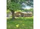 Charming brick home with a well-manicured lawn, mature shade tree, and inviting front porch with benches at 6573 Weldon Nw Cir # 22, Concord, NC 28027