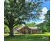 Attractive single-story brick home with mature trees, well-kept lawn, and welcoming front porch at 6573 Weldon Nw Cir # 22, Concord, NC 28027