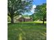 Attractive single-story brick home with mature trees, well-kept lawn, and welcoming front porch at 6573 Weldon Nw Cir # 22, Concord, NC 28027