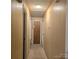 Narrow hallway with carpet and paneled walls at 6573 Weldon Nw Cir # 22, Concord, NC 28027