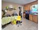 Kitchen features tile floors, wood cabinets, a large countertop, and an eat-in area at 6573 Weldon Nw Cir # 22, Concord, NC 28027