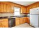 Spacious kitchen with wood cabinetry, tile flooring, window over sink, and modern appliances at 6573 Weldon Nw Cir # 22, Concord, NC 28027
