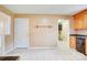 Bright kitchen featuring tile floors, wooden cabinets, and an adjacent doorway at 6573 Weldon Nw Cir # 22, Concord, NC 28027