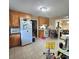 Bright eat-in kitchen with tile flooring, white appliances and wooden cabinets at 6573 Weldon Nw Cir # 22, Concord, NC 28027