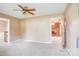 Open living room with carpet, ceiling fan, and doorway leading to another room at 6573 Weldon Nw Cir # 22, Concord, NC 28027