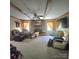 Comfortable living room with brick fireplace, wooden beams, ceiling fan and two comfy leather chairs at 6573 Weldon Nw Cir # 22, Concord, NC 28027