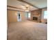 Comfortable living room featuring a brick fireplace, ceiling beams, and neutral carpet at 6573 Weldon Nw Cir # 22, Concord, NC 28027