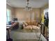 Cozy sitting area features a floral love seat with side pillows and a vintage chandelier at 6573 Weldon Nw Cir # 22, Concord, NC 28027