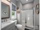 Well-lit bathroom featuring a modern vanity, a glass-enclosed shower, and neutral decor at 7455 Ivey Dr, Sherrills Ford, NC 28673