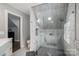 Modern bathroom featuring a glass enclosed shower with marble tiling and a pebble floor design at 7455 Ivey Dr, Sherrills Ford, NC 28673