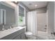 Clean bathroom featuring a shower and bathtub, white vanity, and a window providing natural light at 7455 Ivey Dr, Sherrills Ford, NC 28673
