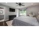 Main bedroom featuring a large bed, dresser, vanity, and windows providing plenty of natural light at 7455 Ivey Dr, Sherrills Ford, NC 28673