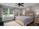 Bedroom featuring a large bed, hardwood floors, vanity, and windows providing plenty of natural light at 7455 Ivey Dr, Sherrills Ford, NC 28673