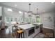 Modern kitchen with a large island, stainless steel appliances, pendant lighting, and an open view to the living room at 7455 Ivey Dr, Sherrills Ford, NC 28673