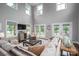 Inviting living room showcasing a comfortable sectional sofa, large windows with lake views, and stylish decor at 7455 Ivey Dr, Sherrills Ford, NC 28673