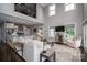 Bright living room featuring soaring ceilings, large windows, and an open layout connecting to the kitchen, with neutral furnishings at 7455 Ivey Dr, Sherrills Ford, NC 28673