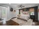 Serene primary bedroom featuring a luxurious bed, dark accent wall, and stylish decor elements at 7455 Ivey Dr, Sherrills Ford, NC 28673