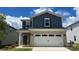 Charming two-story home features a brick and blue vinyl exterior with an attached two-car garage at 820 Blue Canyon Dr, York, SC 29745