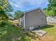 The backyard features a home, greenery, and a few hatches in the ground at 905 Brookdale St, Kannapolis, NC 28083