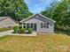 Charming home featuring a well-manicured front yard, gray siding, and black shutters at 905 Brookdale St, Kannapolis, NC 28083