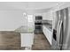 Modern kitchen with stainless steel appliances, granite counters, and an island with bar seating at 905 Brookdale St, Kannapolis, NC 28083