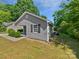 This home boasts gray siding, black shutters, and a well-maintained yard at 905 Brookdale St, Kannapolis, NC 28083