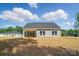 Backyard view featuring a two-story home with neutral-toned siding and a spacious lawn at 908 Westminster Dr, Statesville, NC 28677