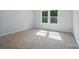 Bright bedroom features neutral carpet, gray walls, and natural light from double windows at 908 Westminster Dr, Statesville, NC 28677
