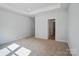 Spacious bedroom boasts neutral carpet, recessed lights and a tray ceiling for added height at 908 Westminster Dr, Statesville, NC 28677