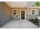 Charming front entrance featuring a stylish door, stone accents, and a covered porch with modern lighting at 908 Westminster Dr, Statesville, NC 28677