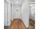 Bright entryway with wood-look flooring, white walls, and a view of the coat closet at 908 Westminster Dr, Statesville, NC 28677