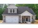 Charming home with gray siding, a white garage door, and well-maintained landscaping at 908 Westminster Dr, Statesville, NC 28677