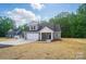 Beautifully designed home showcasing a landscaped front yard, an attached garage, and a welcoming entrance at 908 Westminster Dr, Statesville, NC 28677