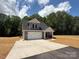 Charming new construction home featuring stone accents, a two-car garage, and a welcoming front porch at 908 Westminster Dr, Statesville, NC 28677