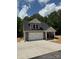 New construction home with a two-car garage, stone accents, and a cozy front porch area at 908 Westminster Dr, Statesville, NC 28677