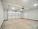 Garage features an automatic door, white walls and plenty of room for parking and storage at 908 Westminster Dr, Statesville, NC 28677