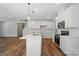Modern kitchen with white cabinets, stainless steel appliances, island, and stylish pendant lighting at 908 Westminster Dr, Statesville, NC 28677