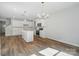 Open concept kitchen view showing island, stainless appliances, and dining area with bright lighting at 908 Westminster Dr, Statesville, NC 28677