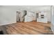 Open living space featuring modern wood floors, sleek white kitchen, and staircase at 908 Westminster Dr, Statesville, NC 28677