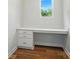 Office area features built-in desk with drawers, quartz countertops, and wood flooring at 908 Westminster Dr, Statesville, NC 28677