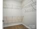 Walk-in closet features wire shelving and neutral carpet for storage at 908 Westminster Dr, Statesville, NC 28677