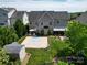 Large backyard showcasing a basketball court, patio area, and landscaped garden, perfect for outdoor activities at 9612 Indian Beech Nw Ave # 1266, Concord, NC 28027