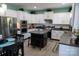 Modern kitchen featuring white cabinets, stainless steel appliances, and a functional center island with seating at 9612 Indian Beech Nw Ave # 1266, Concord, NC 28027