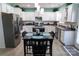 Eat-in kitchen with white cabinets, stainless steel appliances, and a central island at 9612 Indian Beech Nw Ave # 1266, Concord, NC 28027
